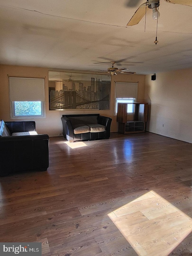 living room with hardwood / wood-style flooring and ceiling fan