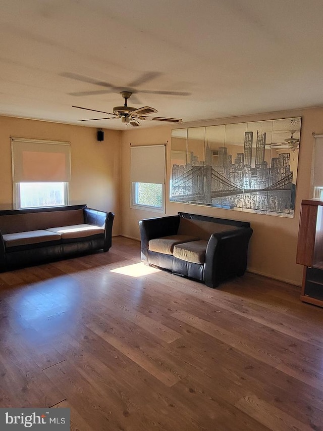 unfurnished living room featuring hardwood / wood-style floors, ceiling fan, and a healthy amount of sunlight