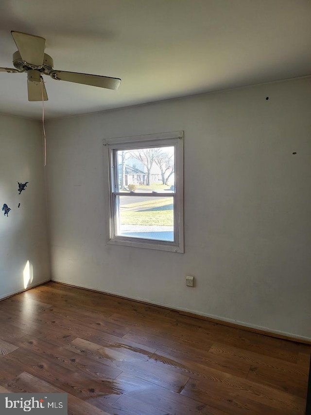 spare room with ceiling fan and dark wood-type flooring