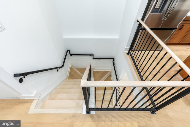 staircase featuring wood-type flooring