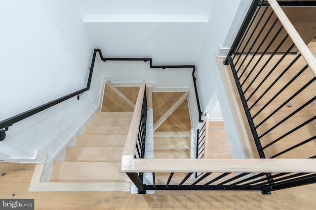 stairs featuring wood-type flooring