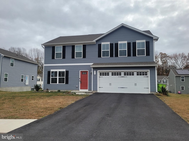 view of front of home featuring a garage and a front lawn