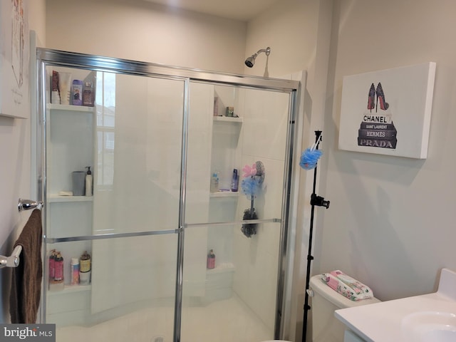 bathroom with vanity, toilet, and an enclosed shower