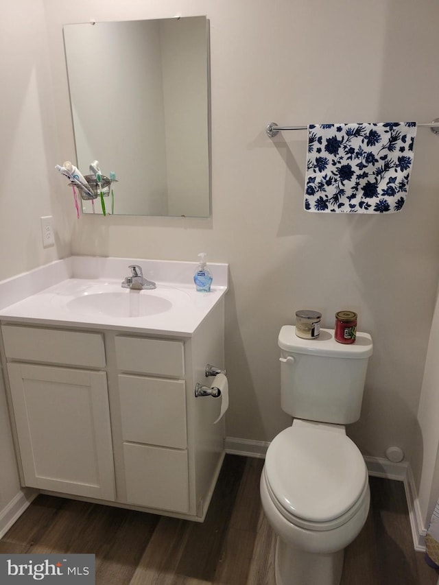 bathroom featuring vanity, toilet, and wood-type flooring