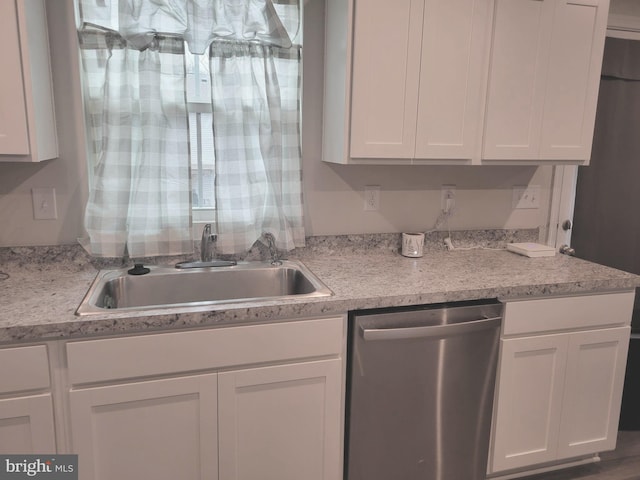 kitchen with white cabinetry, sink, and stainless steel dishwasher