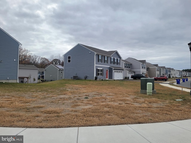 view of front of home featuring a garage and cooling unit