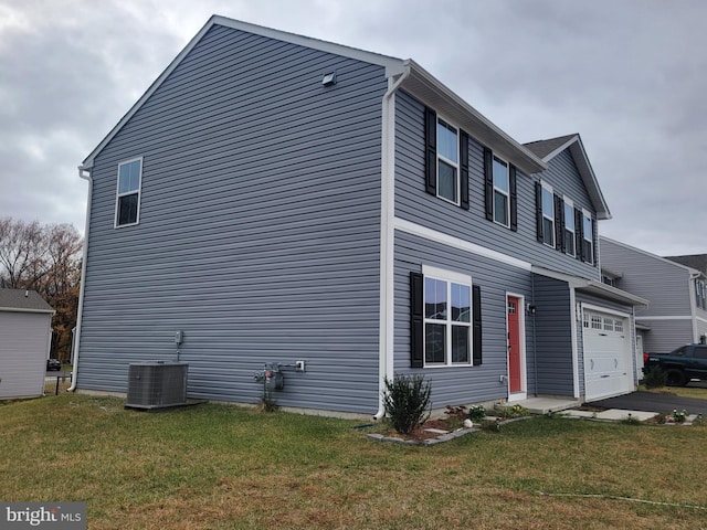 view of property exterior with central air condition unit and a yard