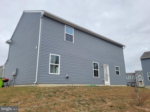 rear view of property with a yard