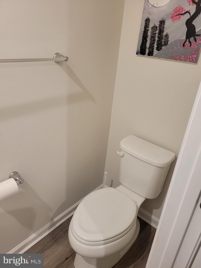 bathroom featuring toilet and wood-type flooring