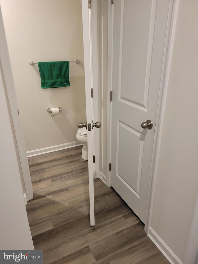 bathroom featuring toilet and hardwood / wood-style flooring