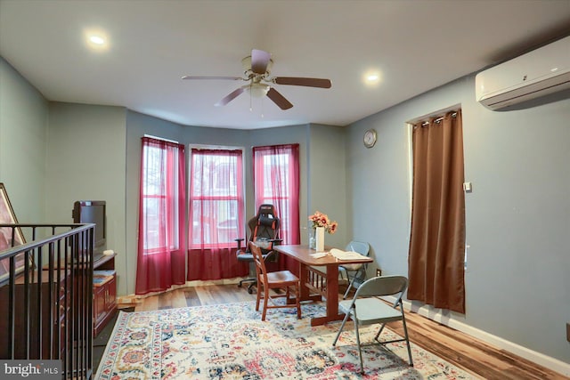 dining area featuring a wall mounted air conditioner, light wood-type flooring, and ceiling fan