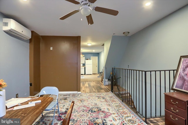 hallway with light wood-type flooring and a wall mounted AC