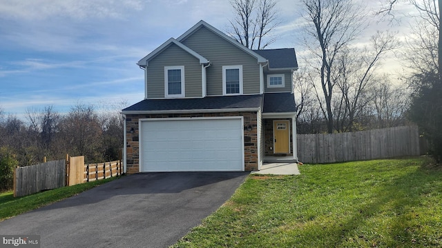 view of property with a garage and a front lawn