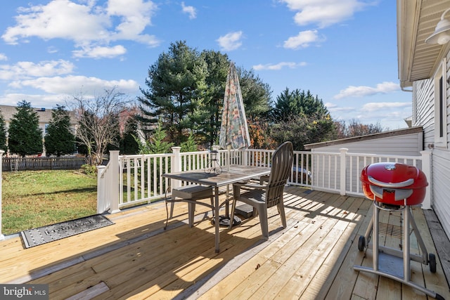 wooden terrace featuring a yard