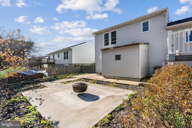 rear view of house with a patio and an outdoor fire pit