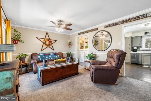 living room with hardwood / wood-style floors, ceiling fan, and crown molding