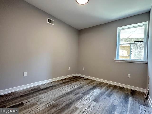 empty room featuring dark wood-type flooring