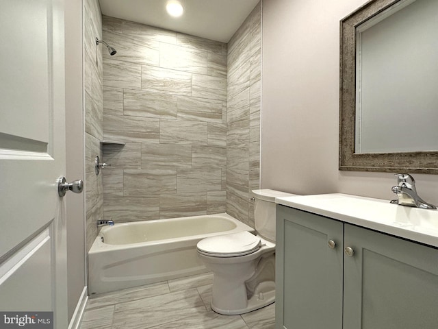 full bathroom featuring vanity, toilet, and tiled shower / bath