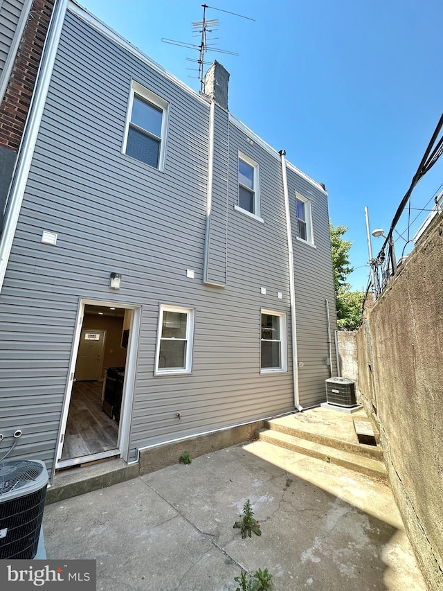 back of house with central AC and a patio area