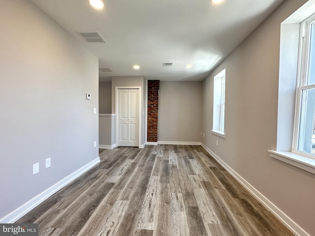 unfurnished room with hardwood / wood-style floors