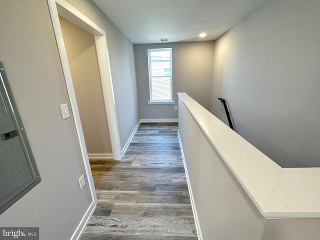 corridor with hardwood / wood-style floors