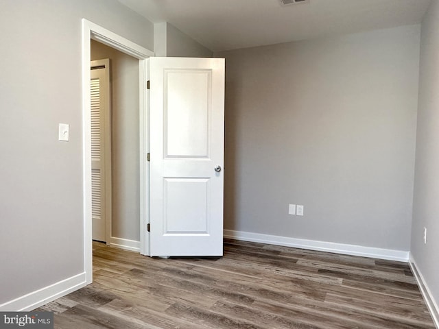 empty room with hardwood / wood-style flooring