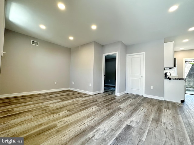 unfurnished living room with light wood-type flooring