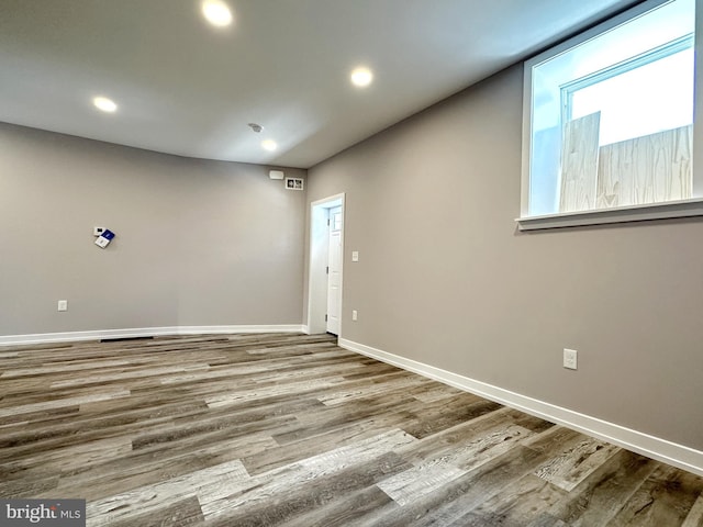 unfurnished room with wood-type flooring