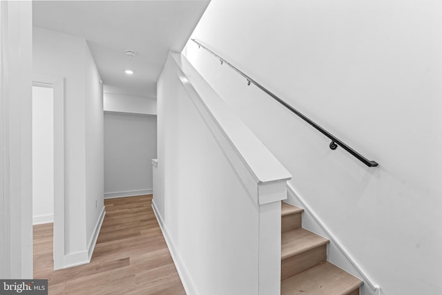 stairs featuring hardwood / wood-style flooring