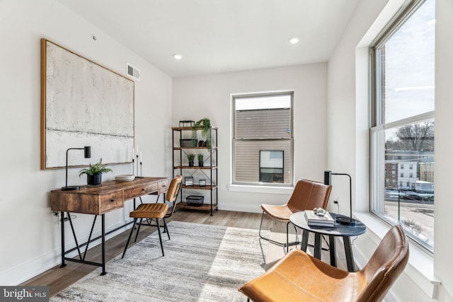 office with a healthy amount of sunlight and light wood-type flooring