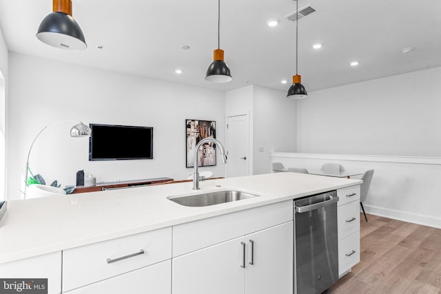 kitchen with sink, white cabinetry, decorative light fixtures, light hardwood / wood-style flooring, and dishwasher