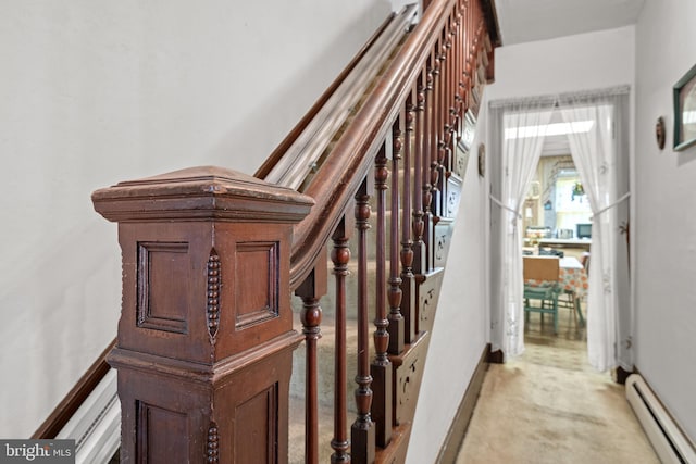 stairs with carpet and a baseboard heating unit