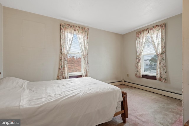 bedroom with carpet, a baseboard radiator, and multiple windows