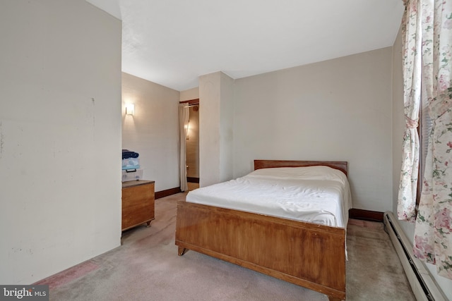 carpeted bedroom with a baseboard radiator