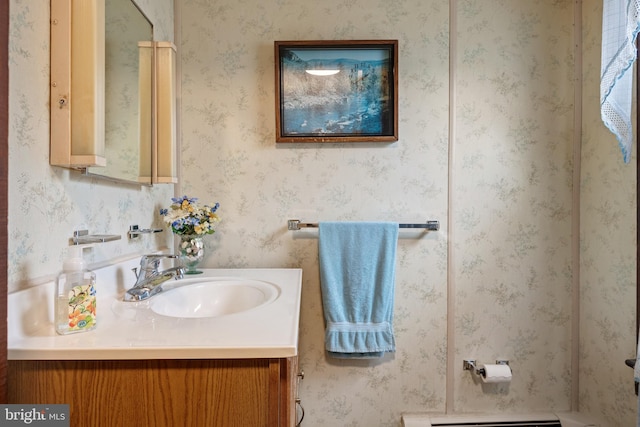 bathroom with vanity and a baseboard heating unit