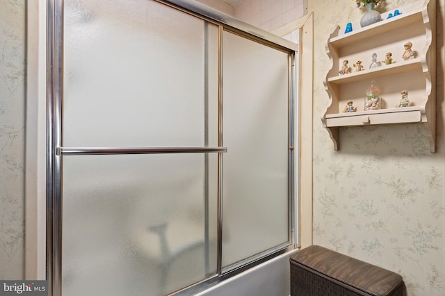 bathroom with shower / bath combination with glass door