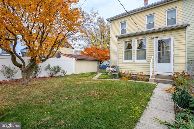 rear view of property with a yard