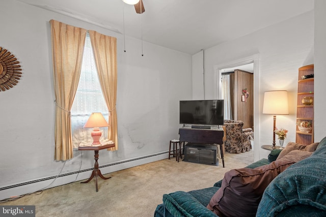 carpeted living room featuring ceiling fan and a baseboard heating unit