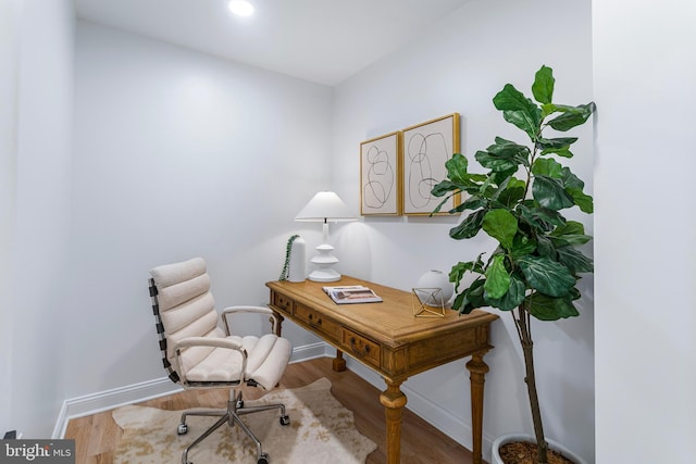 home office with hardwood / wood-style flooring