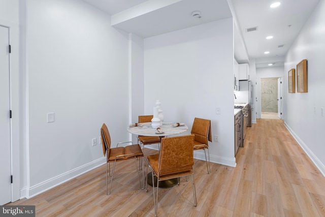 dining space with light hardwood / wood-style floors