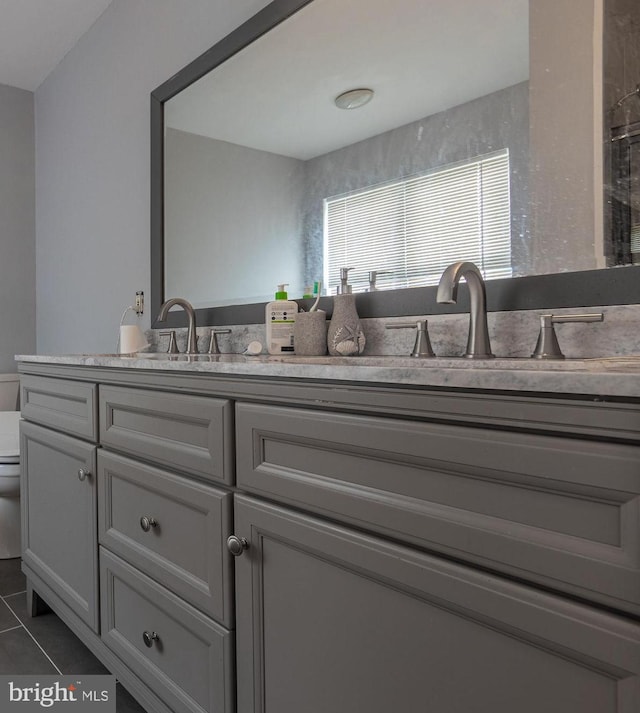 bathroom with tile patterned flooring, vanity, and toilet