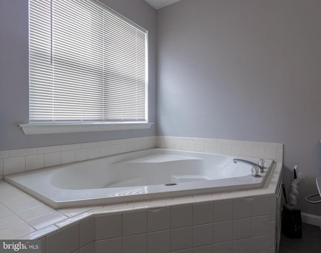 bathroom featuring tiled tub