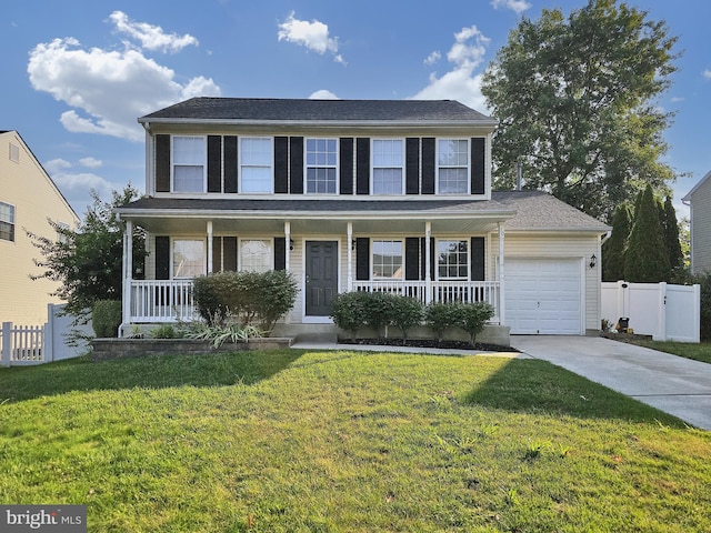 colonial home with covered porch, a garage, and a front yard