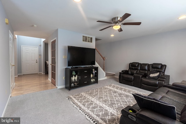 living room featuring wood-type flooring and ceiling fan