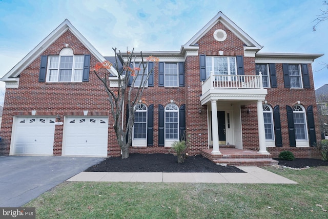 view of front of house featuring a garage and a balcony