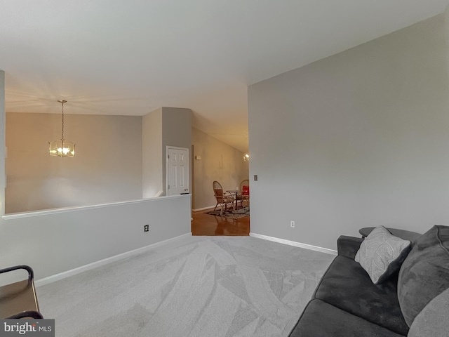 carpeted living room featuring a chandelier