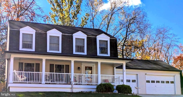 view of front of property featuring a porch and a garage