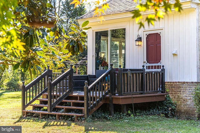 view of exterior entry featuring a lawn