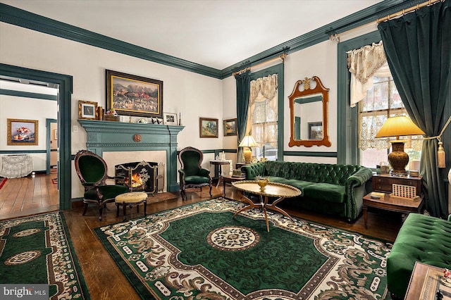 sitting room with hardwood / wood-style floors and ornamental molding