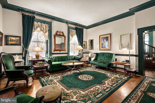 sitting room with ornamental molding, hardwood / wood-style flooring, and a healthy amount of sunlight